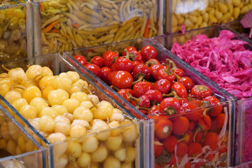 Colorful selection of preserved vegetables at a market