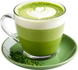 A clear glass mug filled with a layered matcha latte, featuring latte art, sits atop a green saucer with matcha powder spilled beside it.