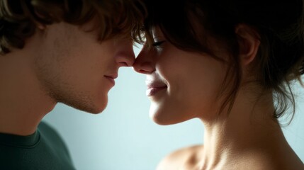 Young couple touching noses sharing an intimate moment with soft smiles and closed eyes
