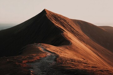 Mountain peak, dawn light, angled ridge, earthy tones, hiking trail