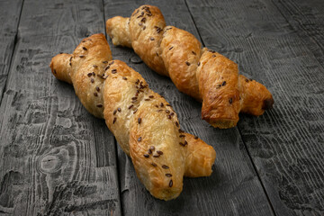 Golden Flaxseed-Studded Pastries on Rustic Wooden Background - Freshly Baked Twists