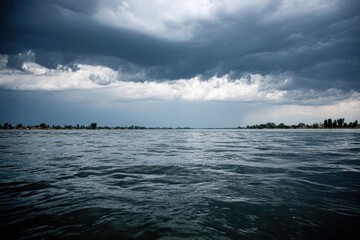 Fototapeta premium Storm clouds over a placid lake
