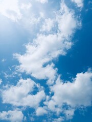 A collection of bright blue sky photographs with various formations of soft white clouds, captured...