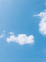 A collection of bright blue sky photographs with various formations of soft white clouds, captured...