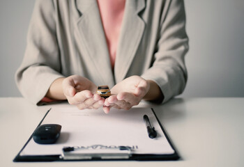Fototapeta premium The hands of a real estate agent are doing calculations. and make a contract regarding car loans