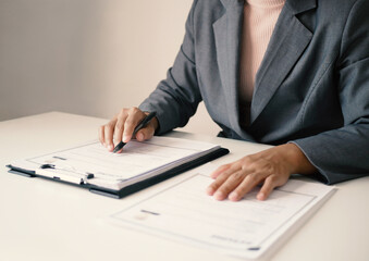 Businesswoman employer holding resume, recruiting, planning, evaluating and reviewing resume of job...