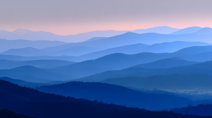 Obraz premium Layered blue mountain silhouettes fading into the horizon at dusk 