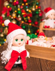 Festive doll in Santa hat, near Christmas tree and gifts