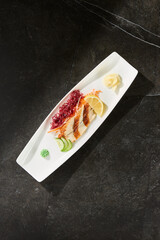 Eel sashimi with pickled ginger, moody lighting, overhead composition, on elongated white plate