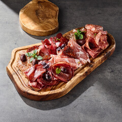 Assorted cured meats platter, rustic bright lighting, overhead composition