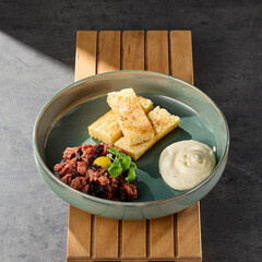 Beef tartare with brioche and parmesan mousse, bright lighting, overhead composition