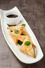 Crab turnovers with golden crust, bright lighting, overhead composition on white ceramic plate