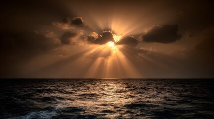 Obraz premium Sunlight breaking through dark clouds over a vast ocean.