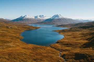 Majestic Snow-Capped Mountains Overlooking a Serene Blue Lake