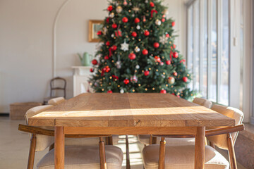 Wooden table with decorated Christmas tree background