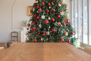 Wooden table with decorated Christmas tree background