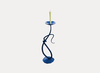 The white background in the picture is a black patterned candle holder with a base and a dark blue...