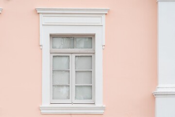 Close-up of the historic facade of a pink building showcasing classic architecture