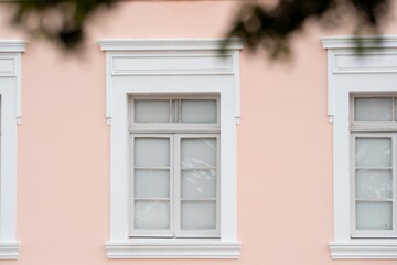 Close-up of the historic facade of a pink building showcasing classic architecture