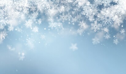 Fototapeta premium Snowflakes falling on a light blue background