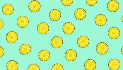 A repeating pattern of sliced pineapples on a bright turquoise background, creating a vibrant and summery design.