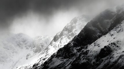 Obraz premium Snowy mountain peaks shrouded in mist.