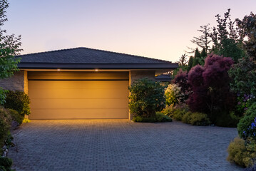 Garage door in luxury house with trees and nice landscape in Spring in Vancouver, Canada, North...