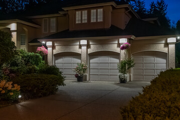 Garage door in luxury house with trees and nice landscape in Spring in Vancouver, Canada, North...