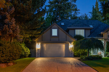 Garage door in luxury house with trees and nice landscape in Spring in Vancouver, Canada, North...