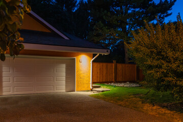 Garage door in luxury house with trees and nice landscape in Spring in Vancouver, Canada, North...