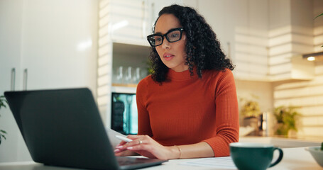 Woman, laptop and documents for remote work from home, review and scroll for report in kitchen....