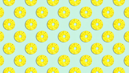 A repeating pattern of sliced pineapple rings arranged on a light blue background.