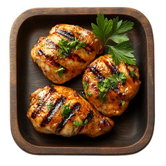 Top view of a delicious looking grilled chicken on a dark wooden tray isolated on a white transparent background