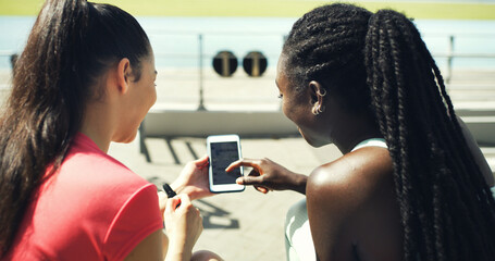 Runner, phone screen and scroll with friends in stadium for training schedule, team or sports. Fitness app, communication and exercise guide with women on race track for social media and online chat