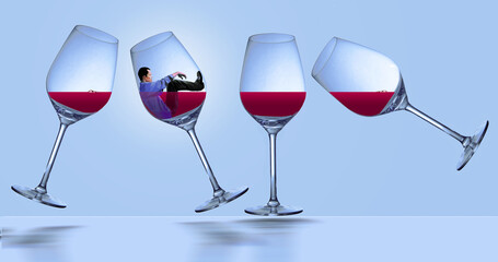 A man with a drinking problem is pictured trapped inside a stemware wine glass