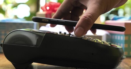 Payment made with smartphone using nfc system mobile phone on cash machine paying modern smart technology business transaction - Powered by Adobe