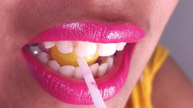 Lollipops, Female mouth licks sweet stick candy. Sexy Indian girl eating popsicles or chupa chups close-up. Woman lips sucking Tootsie Pops. Sensual sex shop concept. Sexual dreams. Pleasure. 