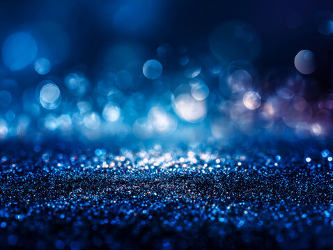 Sparkling blue bokeh and glittering surface creating a vibrant abstract background