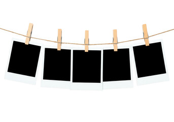 Blank polaroid photos hanging on a string with clothespins, isolated on transparent background