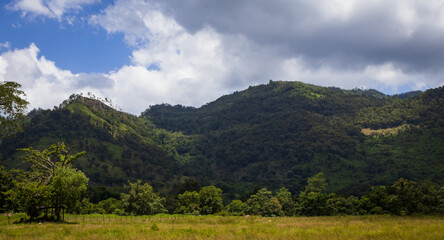 Mountain Panorama: A majestic panoramic view showcases rolling hills and a vast plain beneath a...