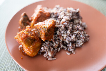 Wild rice served with spicy Nigerian tomato pepper stew