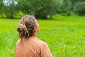 Mature female enjoying nature in a green park setting