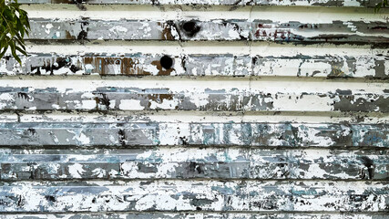 Dirty white grunge background with peeling paint for creative projects.