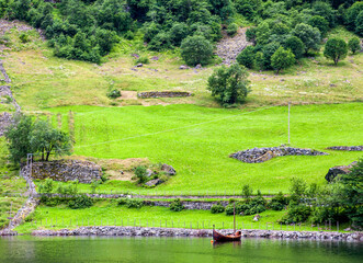 Traditional Wooden Boat on the Shores of a Norwegian Fjord
