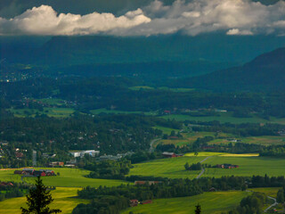 Overlooking a Norwegian Town and Forest Under Dramatic Skies on white night