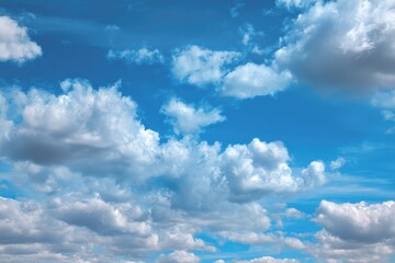 Vast blue sky dotted with fluffy clouds