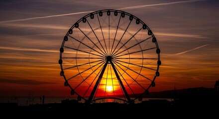 Spectacular sunset silhouette: Majestic Ferris wheel against twilight skies with serene horizon