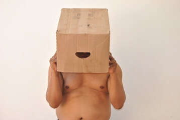Anonymous Struggles: Overweight Man Hiding Behind a Cardboard Box
