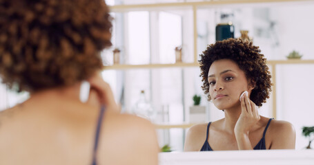 Girl, mirror and cotton pad for beauty in home, cleaning or hygiene with makeup removal or skin toner. Self care, routine and African woman at house with reflection for dermatology and skincare © peopleimages.com