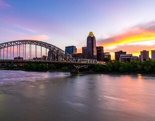 Naklejka premium City skyline at sunset over a river (2)